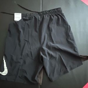 Black Nike shorts with hint of brown on the front flaps